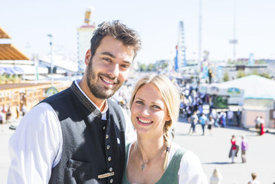 Portrait of smiling couple standing outdoors