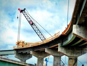 Low angle view of bridge construction against sky