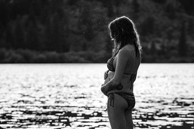 Woman standing by water on land