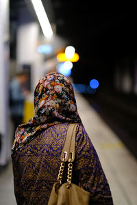 Rear view of woman with umbrella