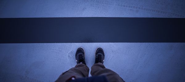 Low section of man standing in city