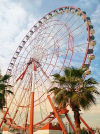 Low angle view of ferris wheel against sky