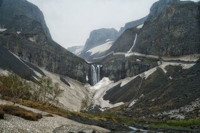 Scenic view of mountains and waterfall