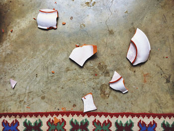 High angle view of broken plate on floor