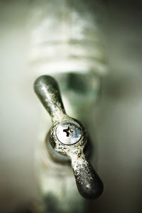 Close-up of old faucet in bathroom