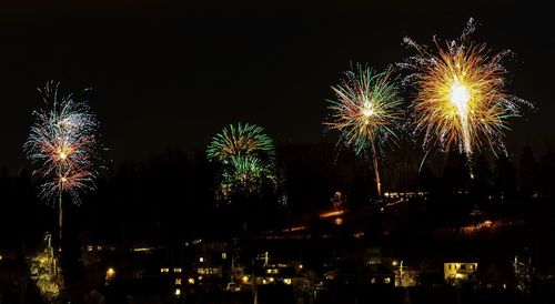 Low angle view of firework display at night