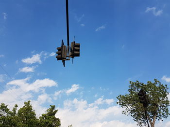 Low angle view of traffic signal against blue sky