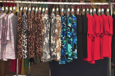 Tops hanging in row at clothing store