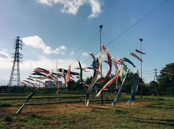 Clothes hanging on field against sky