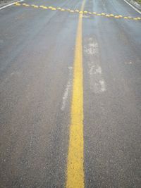 High angle view of yellow arrow symbol on road