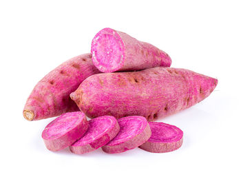 Close-up of pink fruits against white background