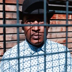 Portrait of man standing on metal grate