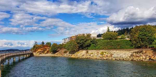 Arch bridge over river against sky