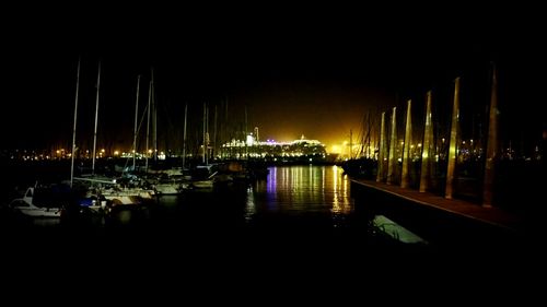 Boats in harbor at night