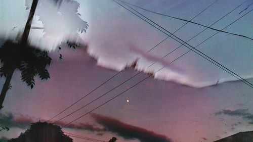 Low angle view of power lines against sky at dusk