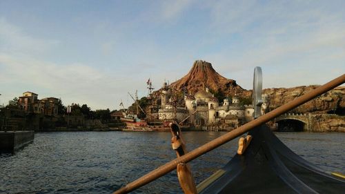 Boats in river with buildings in background