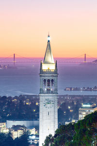 Suther tower in uc berkeley with golden gate bridge as background