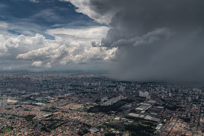 Aerial view of buildings in city against sky