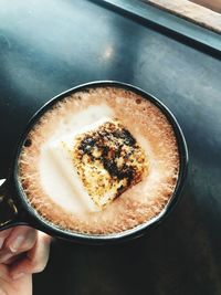 Cropped image of hand holding coffee cup