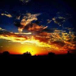 Silhouette of landscape against dramatic sky