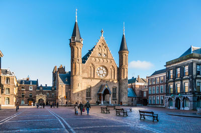 Group of people in front of buildings in city