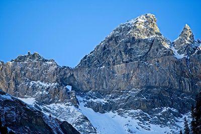 Scenic view of snowcapped mountains against clear blue sky