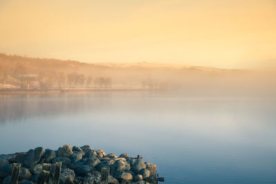 Scenic view of lake against sky during sunset