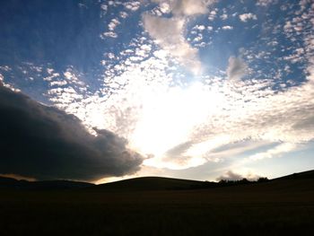 Scenic view of landscape against cloudy sky