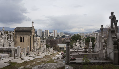 Panoramic view of buildings in town against sky