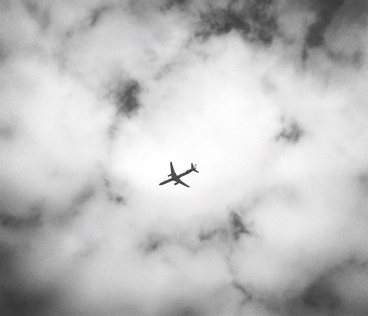 CLOSE-UP OF AIRPLANE IN SKY