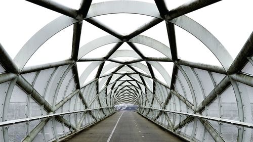 Low angle view of footbridge against sky