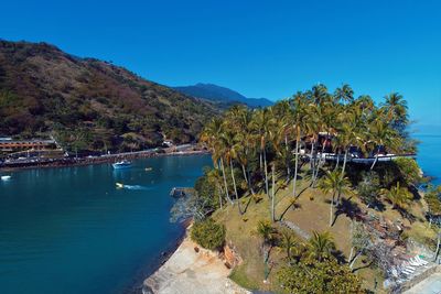 Scenic view of sea against clear blue sky