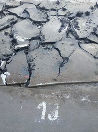 High angle view of broken sign on road