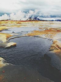 Scenic view of sea against cloudy sky