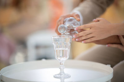 Midsection of woman drinking glass