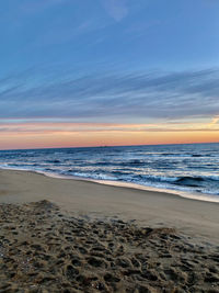 Scenic view of beach against sky during sunset