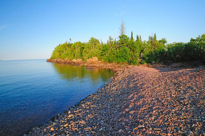 Scenic view of sea against clear blue sky