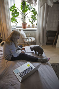 Woman sitting on bed