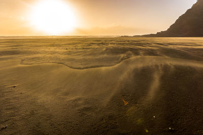 Scenic view of beach against sky during sunset