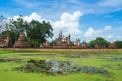 Panoramic view of temple by building against sky