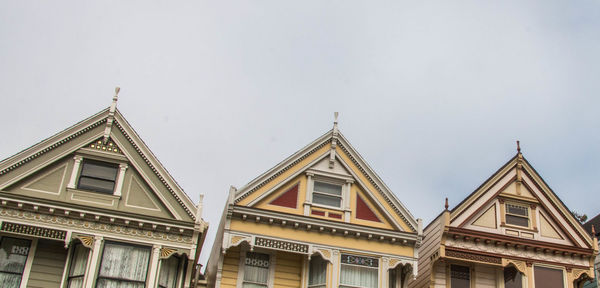 Low angle view of buildings against cloudy sky