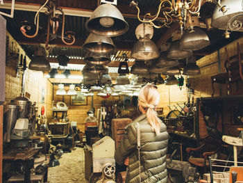 Woman standing in illuminated store