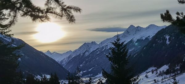 Scenic view of snowcapped mountains against sky during sunset