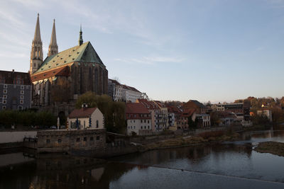 Buildings in town against sky