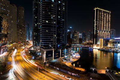 Illuminated cityscape against sky at night