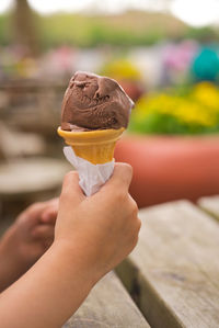 Close-up of hand holding ice cream cone