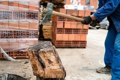 Low section of man working on wood