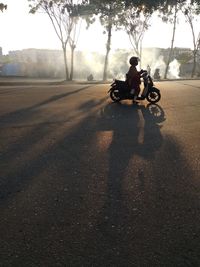 Man riding motorcycle on street in city