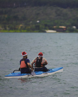 Rear view of people in boat