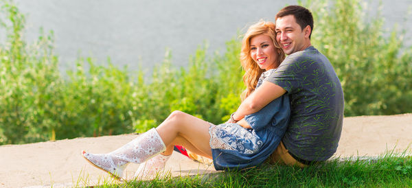 Young couple sitting outdoors